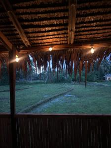 a view of a field from a porch with lights at RM's Tourist Inn in Carmen