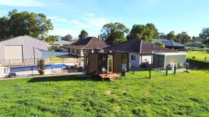 a house with a dog sitting in a yard at Tiny Home in the Hills by Tiny Away in Perth +14 photos
