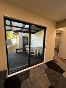 a dining room with sliding glass doors leading to a patio at 2 Bedroom Comfortable Guest Wing in Hamilton