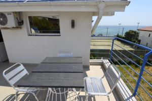 a table and chairs on the balcony of a house at Harmony Villa in Costinesti