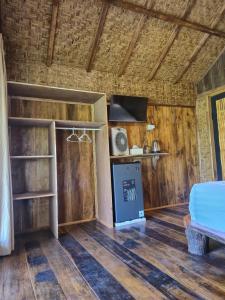 a room with a bed and a stove in it at Lombok Rice Terracce Glamping in Tetebatu