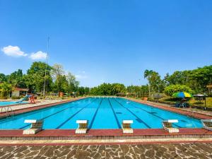 a large swimming pool in a park at Megamendung Hotel & Resort in Ciguntur +4 photos