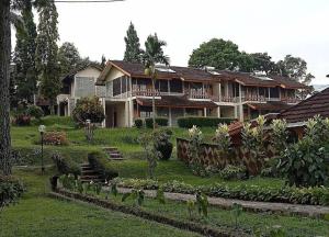 a house with a garden in front of it at Megamendung Hotel & Resort in Ciguntur