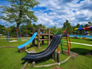 a playground with a slide in a park at Megamendung Hotel & Resort in Ciguntur