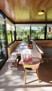 a long table in a room with a large window at Retiro de Las Cañas in Fray Bentos
