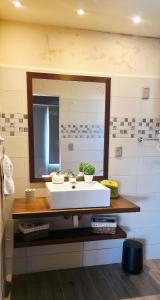 a bathroom with a sink and a large mirror at Retiro de Las Cañas in Fray Bentos +27 photos