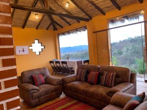 a living room with two couches and a dining table at Mountain View Lodge & Experience in Cusco
