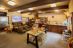 a large room with a living room with a table at Kusatsu Onsen Eidaya in Kusatsu