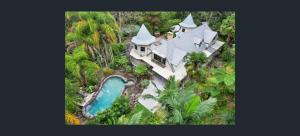 an aerial view of a large house with a swimming pool at Gorge Castle in forest landscape in Galston