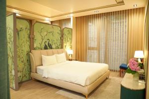 a bedroom with a large bed and a window at Samten Hills Villa Dalat in Xuan An