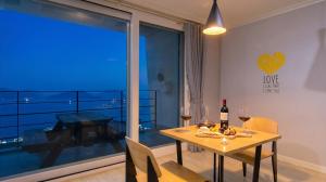 a dining room with a table with wine glasses at Yeosu Harushimpyo Pension in Yeosu