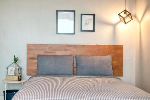 a bedroom with a bed with three pictures on the wall at Yeosu Harushimpyo Pension in Yeosu