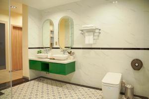 a bathroom with two sinks and two mirrors at Samten Hills Villa Dalat in Xuan An +26 photos