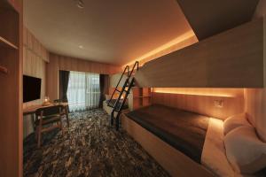 a bedroom with a bunk bed and a desk at Moat Inside Hakata in Fukuoka
