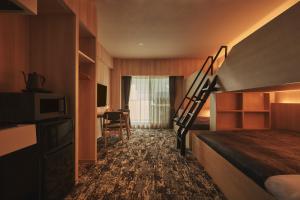 a hotel room with a bunk bed and a staircase at Moat Inside Hakata in Fukuoka