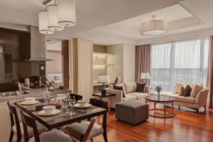 a kitchen and living room with a table and chairs at Crowne Plaza Shanghai Anting-20 Minutes drive to National Exhibition and Convention Center & 15 Minutes drive to F1 in Jiading