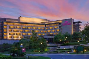 a hotel building with a sign on it at dusk at Crowne Plaza Shanghai Anting-20 Minutes drive to National Exhibition and Convention Center & 15 Minutes drive to F1 in Jiading