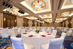 a ballroom with white tables and chairs and chandeliers at Crowne Plaza Shanghai Anting-20 Minutes drive to National Exhibition and Convention Center & 15 Minutes drive to F1 in Jiading +174 photos
