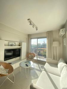a living room with a couch and a table at 9 de Julio Park Suites in San Miguel de Tucumán