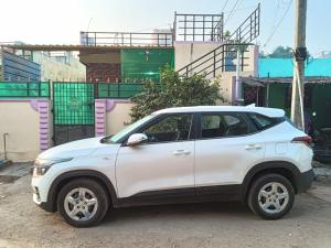 a white car parked in front of some buildings at Siddhartha homevibes hampi in Hampi