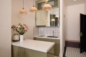 a kitchen with a counter and a sink and lights at APT Hotel Phan Rang in Phan Rang–Tháp Chàm +58 photos