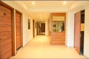 a hallway of a house with wooden doors at Hotel Layover Stay-3 Minutes From the Airport in Jaipur