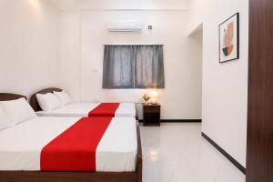 a hotel room with two beds and a window at Wonder Stay in Jaffna