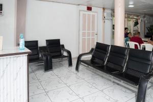 a waiting room with black chairs and a counter at En Pensionne Comfort in Iloilo City