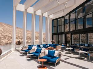 a rendering of a lobby with blue chairs and tables at Zel Fuerteventura in Costa Calma +54 photos