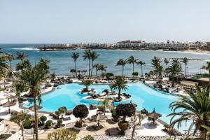 an aerial view of a resort with a pool and the ocean at Paradisus Salinas Lanzarote - All Inclusive - Adults Only in Costa Teguise