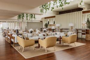 a lobby with white furniture and tables and chairs at Paradisus Salinas Lanzarote - All Inclusive - Adults Only in Costa Teguise +114 photos