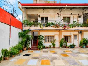 an old building with a balcony and plants at EnPensionne Hotel in Iloilo City
