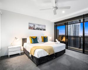 a bedroom with a large bed and a large window at Circle on Cavill Apartments - Hosted by WowStay in Gold Coast +112 photos