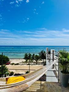 a hammock on the beach with a view of the ocean at Studio RoofTop with amazing view in Mahahual