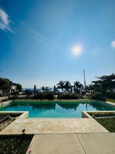a swimming pool with the ocean in the background at Studio RoofTop with amazing view in Mahahual