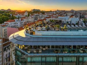 an overhead view of a building with a sunset in the background at ME by Meliá Lisbon in Lisbon