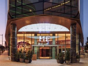 a store front of a building with potted plants at ME by Meliá Lisbon in Lisbon