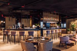 a restaurant with tables and chairs and a bar at ME by Meliá Lisbon in Lisbon +86 photos