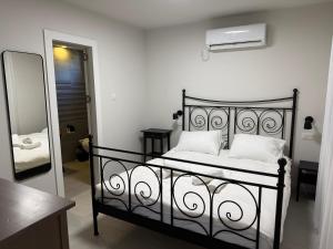 a black bed with white pillows and a mirror at סוויטות שריתא in Shomera +17 photos