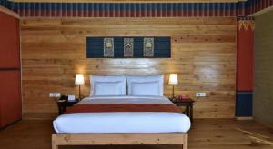 a bedroom with a bed with a wooden wall at Hotel Valley Thimphu in Tshalunang +105 photos