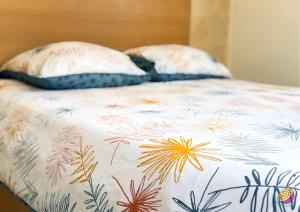 two pillows sitting on top of a bed at Studio Belle Place in Le Gosier