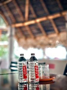 two bottles of water sitting on top of a table at Serenity beach side in Pondicherry