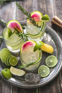 a plate with two glasses of apples and lime slices at Boutique KAS Luxury Hotel in Ho Chi Minh City