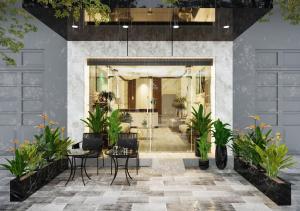a lobby with plants in front of a building at Boutique KAS Luxury Hotel in Ho Chi Minh City