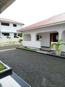 a house with a gravel driveway in front of it at Havilla Cecilia in Watamu