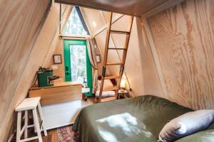 a bedroom with a bed and a desk and a ladder at Romantic A-Frame Couples Retreat Cozy and 12 Acres in Rockbridge