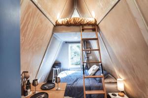 a room with a bunk bed in a tiny house at Charming A-Frame Couples Retreat Cozy and Private in Rockbridge