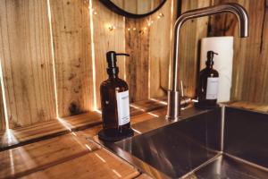 two bottles of wine sitting on a counter next to a sink at Charming A-Frame Couples Retreat Cozy and Private in Rockbridge +35 photos