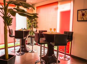 een restaurant met 2 tafels en stoelen met wijnglazen bij The Originals City, Hôtel Ascotel, Lille Est Grand Stade (Inter-Hotel) in Villeneuve d'Ascq