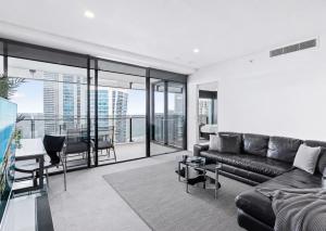 a living room with a couch and a table at Circle on Cavill Apartments - Hosted by WowStay in Gold Coast